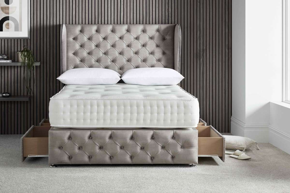 divan-storage-options-tile Grey buttoned divan bed with two storage drawers open on each side.